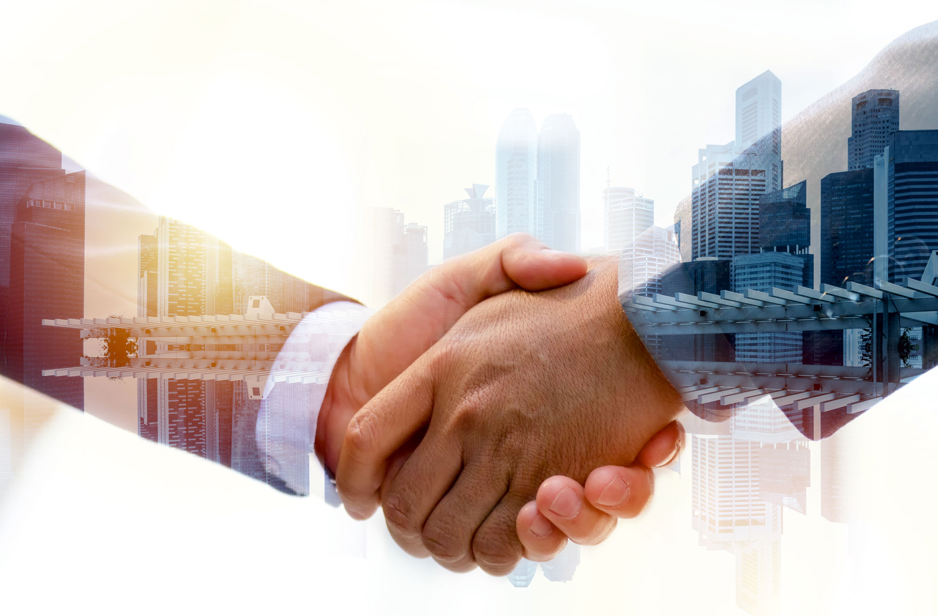 Business handshake with city skyline